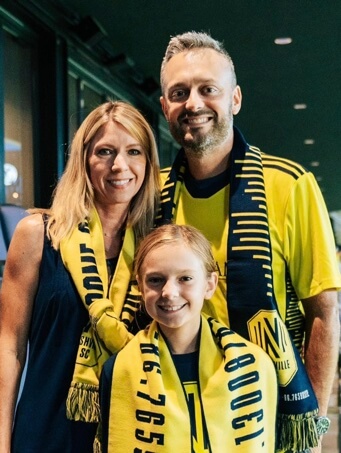 Laura Baines with her husband and their daughter.